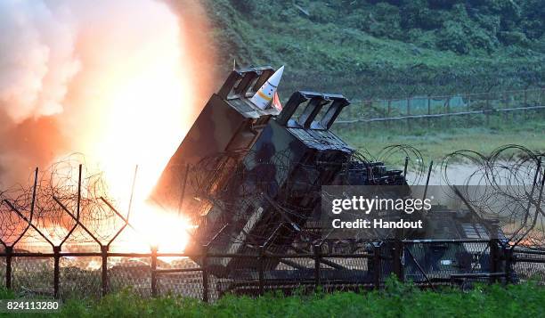 In this handout photo released by the South Korean Defense Ministry, U.S. Army Tactical Missile System firing a missile into the East Sea during a...