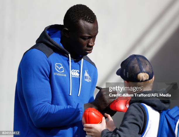 Majak Daw of the Kangaroos signs autographs during the 2017 AFL round 19 match between the North Melbourne Kangaroos and the Melbourne Demons at...