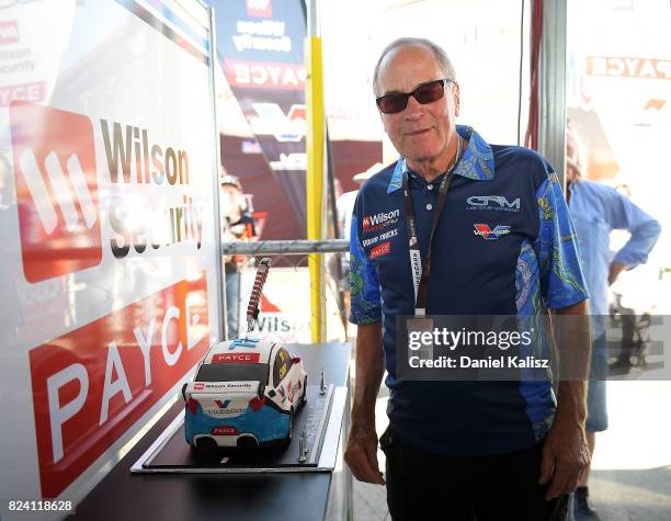 Garry Rogers, team owner of Garry Rogers Motorsport poses for a photo with a cake presented for his birthday during qualifying for race 15 of the...