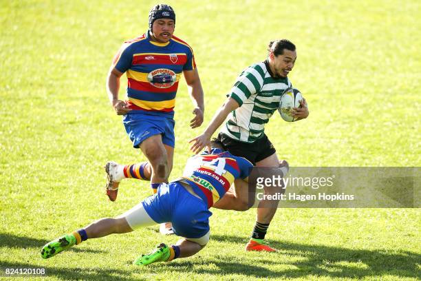 Te Wehi Wright of Old Boys-University is tackled by PJ Iosefo of Tawa during the Jubilee Cup Semi Final match between Old Boys-University and Tawa at...