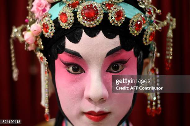 In this picture taken on July 28, 2017 Chinese Cantonese opera actress Mia Zhao from Beijing poses backstage before an opera performance in Kuala...