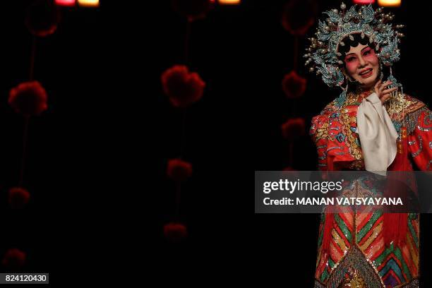 In this picture taken on July 28, 2017 an ethnic Malaysian-Chinese Cantonese opera actress Veronica Davis from the Sound of Tai Hei group performs on...