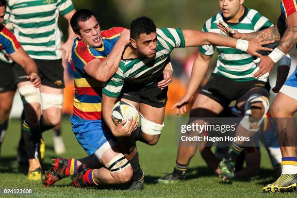 Teariki Ben-Nicholas of Old Boys-University is tackled by Hemi Fermanis of Tawa during the Jubilee Cup Semi Final match between Old Boys-University...