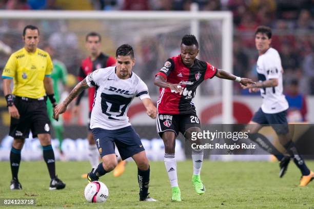 Clifford Aboagye of Atlas fights for the ball with David Cabrera of Pumas during the 2nd round match between Atlas and Pumas UNAM as part of the...