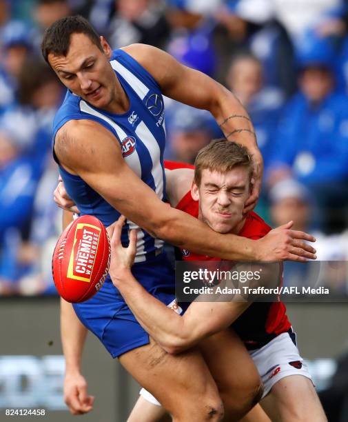 Braydon Preuss of the Kangaroos and Oscar McDonald of the Demons compete for the ball during the 2017 AFL round 19 match between the North Melbourne...