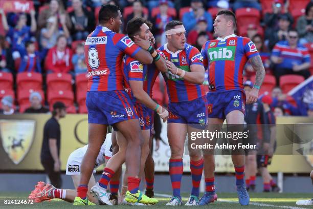 Brock Lamb of the Knights celebrates his try with team mates during the round 21 NRL match between the Newcastle Knights and the St George Illawarra...