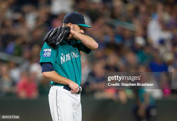 Relief pitcher David Phelps of the Seattle Mariners reacts after giving up an RBI-single to Neil Walker of the New York Mets that scored Asdrubal...