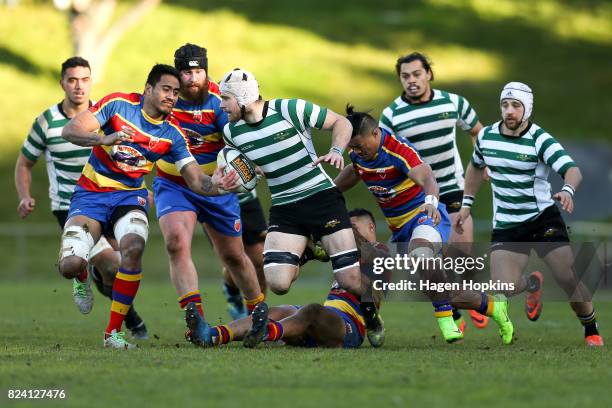 Sam Coventry of Old Boys-University is tackled during the Jubilee Cup Semi Final match between Old Boys-University and Tawa at Jerry Collins Stadium...