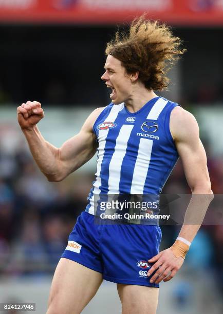 Ben Brown of the Kangaroos celebrates kicking a goal during the round 19 AFL match between the North Melbourne Kangaroos and the Melbourne Demons at...