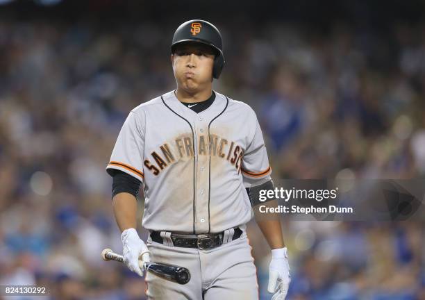 Jae-gyun Hwang of the San Francisco Giants reacts after striking out looking for the second out of the ninth inning against closer Kenley Jnsen of...