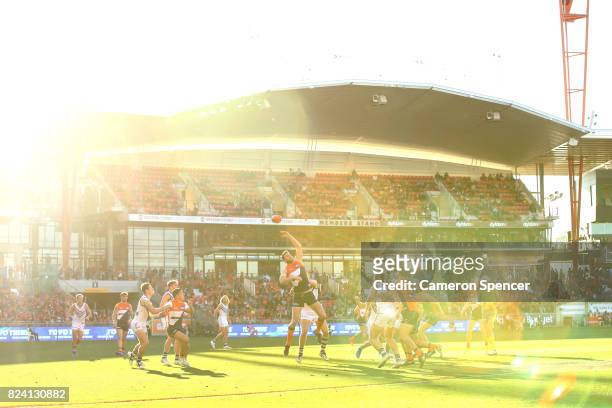 Dawson Simpson of the Giants taps the ball during the round 19 AFL match between the Greater Western Sydney Giants and the Fremantle Dockers at...
