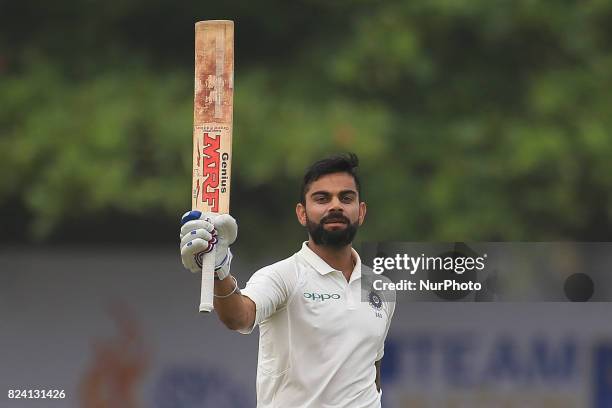 Indian cricket captain Virat Kohli celebrates after scoring 100 runs during the 4th Day's play in the 1st Test match between Sri Lanka and India at...