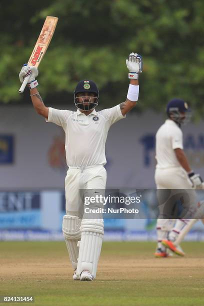 Indian cricket captain Virat Kohli celebrates after scoring 100 runs during the 4th Day's play in the 1st Test match between Sri Lanka and India at...