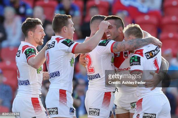 Paul Vaughan of the Roosters celebrates his try with team mates during the round 21 NRL match between the Newcastle Knights and the St George...