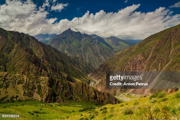 view from pass to green valley and the mountains. kyrgyzstan - bishkek stock pictures, royalty-free photos & images