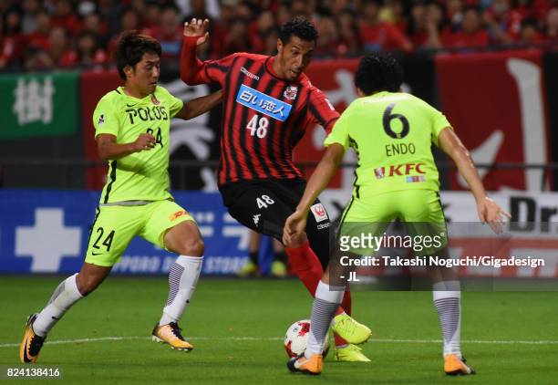 Jay Bothroyd of Consadole Sapporo competes for the ball against Takahiro Sekine and Wataru Endo of Urawa Red Diamonds during the J.League J1 match...