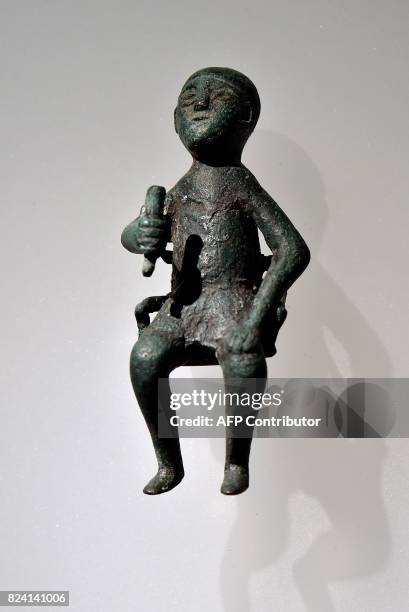 Bronze statuette of a Tamada depicting a person drinking wine from a bovine horn found in Georgia dating from the VII-VI century BC on display at an...