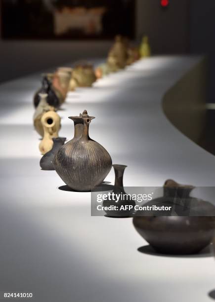 Georgian wine carafes dating from several different eras sit on display at an exhibition at The Cité du Vin in Bordeaux on July 28, 2017. Georgia,...