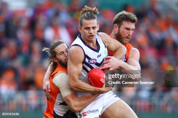 Nat Fyfe of the Dockers is tackled by Dawson Simpson of the Giants during the round 19 AFL match between the Greater Western Sydney Giants and the...