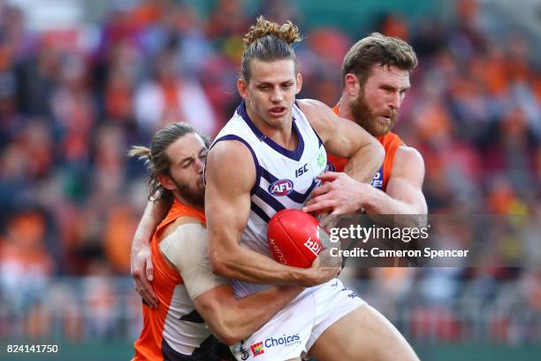 Nat Fyfe of the Dockers is tackled by Dawson Simpson of the Giants during the round 19 AFL match between the Greater Western Sydney Giants and the...