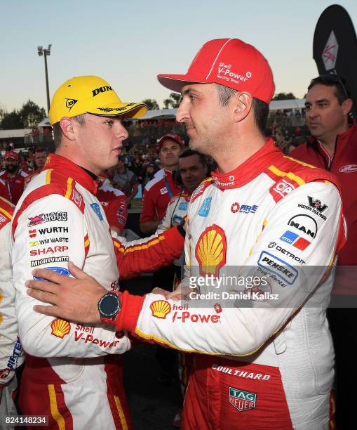 Race winner Scott McLaughlin driver of the Shell V-Power Racing Team Ford Falcon FGX is congratulated by his team mate Fabian Coulthard driver of the...