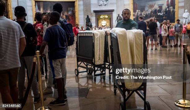 On a day that promises to be long, a Capitol Hill employee delivers cots to Senator's hideaways just off the Senate floor before votes concerning the...