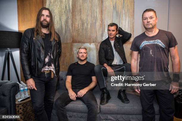 Gavin Rossdale, Robin Goodridge, Chris Traynor and Corey Britz of Bush pose for a photo backstage before their concert at the Hollywood Palladium on...