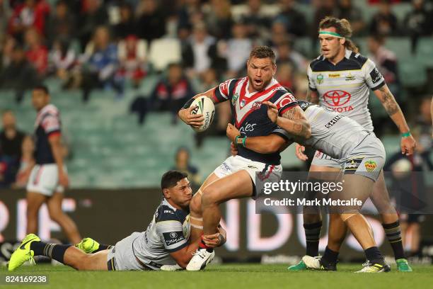 Jared Waerea-Hargreaves of the Roosters is tackled during the round 21 NRL match between the Sydney Roosters and the North Queensland Cowboys at...