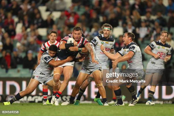 Jared Waerea-Hargreaves of the Roosters is tackled during the round 21 NRL match between the Sydney Roosters and the North Queensland Cowboys at...