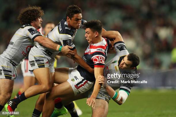 Joseph Manu of the Roosters is tackled during the round 21 NRL match between the Sydney Roosters and the North Queensland Cowboys at Allianz Stadium...