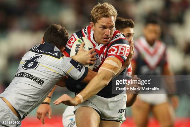 Mitchell Aubusson of the Roosters is tackled during the round 21 NRL match between the Sydney Roosters and the North Queensland Cowboys at Allianz...