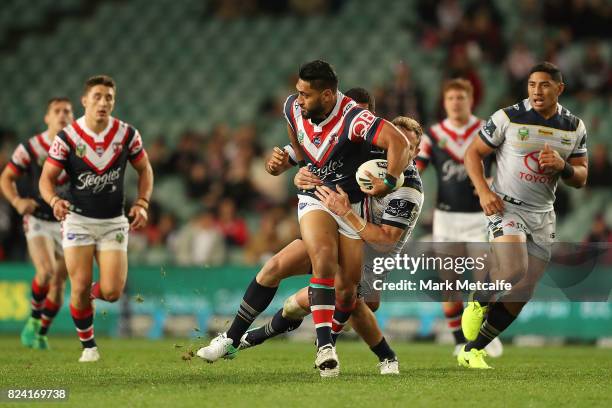 Isaac Liu of the Roosters is tackled during the round 21 NRL match between the Sydney Roosters and the North Queensland Cowboys at Allianz Stadium on...