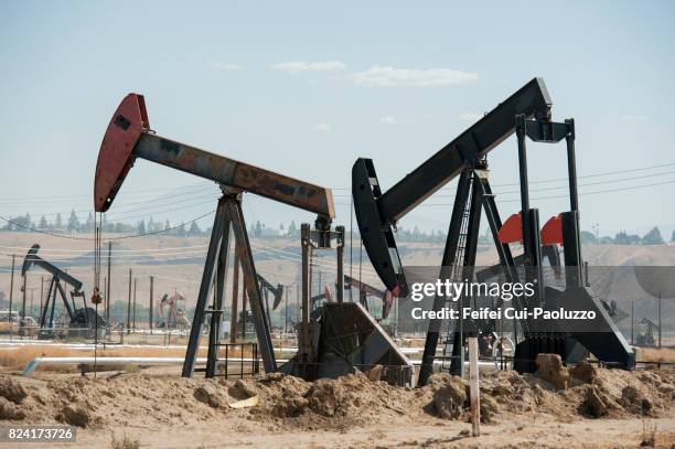 oil field and oil pump near bakersfield, california, usa - lost hills california stock pictures, royalty-free photos & images