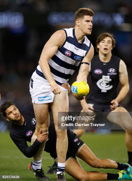 Sam Petrevski-Seton of the Blues tackles Zac Smith of the Cats during the round 19 AFL match between the Carlton Blues and the Geelong Cats at Etihad...