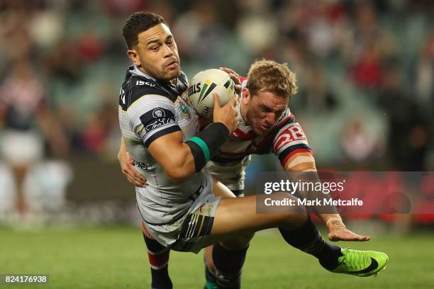 Antonio Winterstein of the Cowboys is tackled by Mitchell Aubusson of the Roosters during the round 21 NRL match between the Sydney Roosters and the...