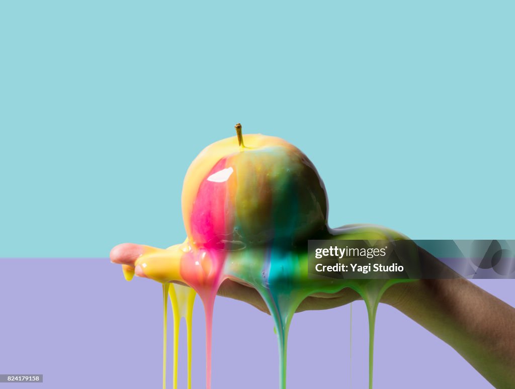 Apple and slime on color blocked background