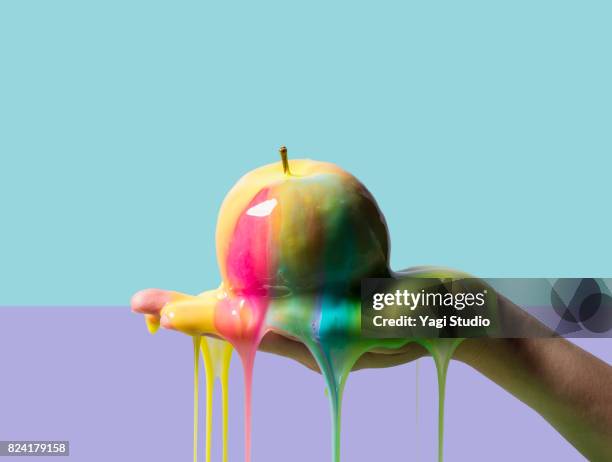 apple and slime on color blocked background - sticky imagens e fotografias de stock