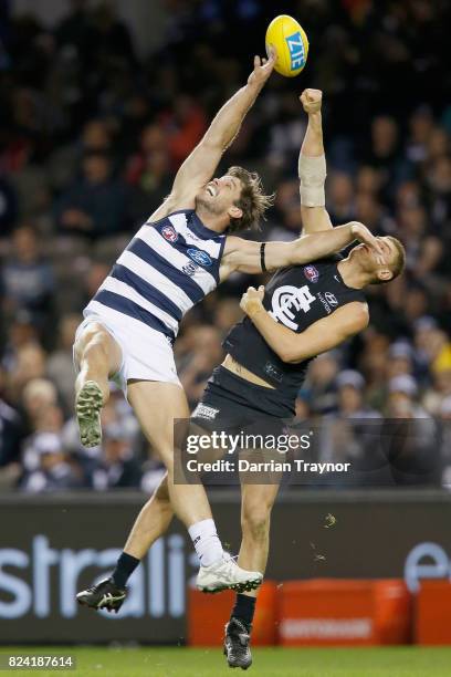 Tom Hawkins of the Cats and Liam Jones of the Blues compete during the round 19 AFL match between the Carlton Blues and the Geelong Cats at Etihad...