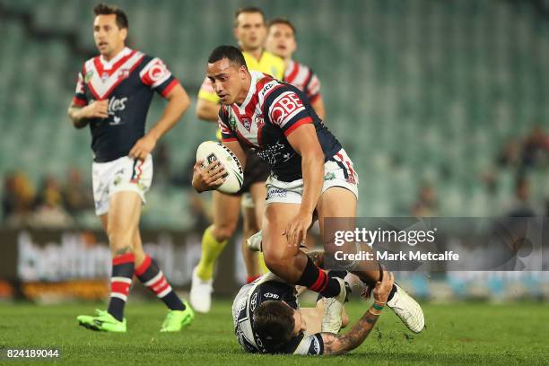 Sio Siua Taukeiaho of the Roosters is tackled during the round 21 NRL match between the Sydney Roosters and the North Queensland Cowboys at Allianz...