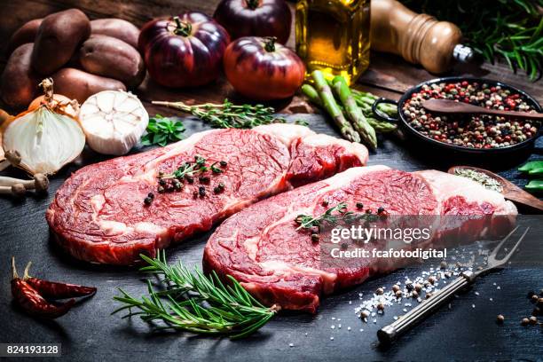 raw fresh beef steak fillets on dark background - slate rock stock pictures, royalty-free photos & images