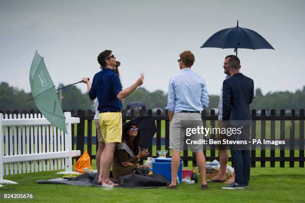 Spectators with a picnic at the Royal Salute Coronation Cup polo at Windsor Great Park in Surrey.