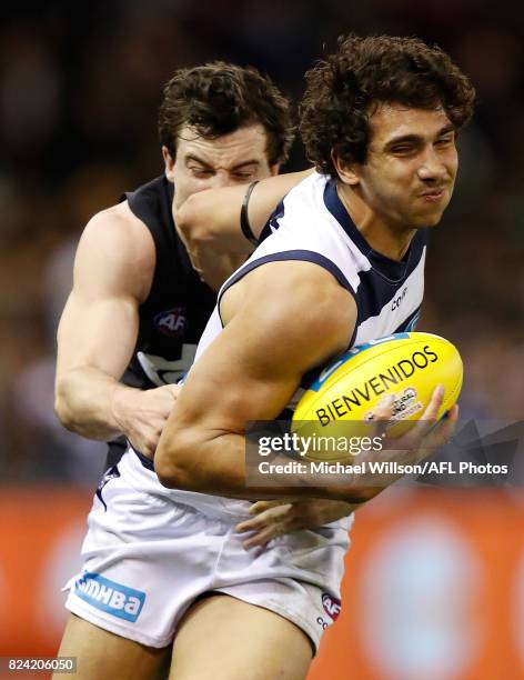 Nakia Cockatoo of the Cats is tackled by Lachie Plowman of the Blues during the 2017 AFL round 19 match between the Carlton Blues and the Geelong...