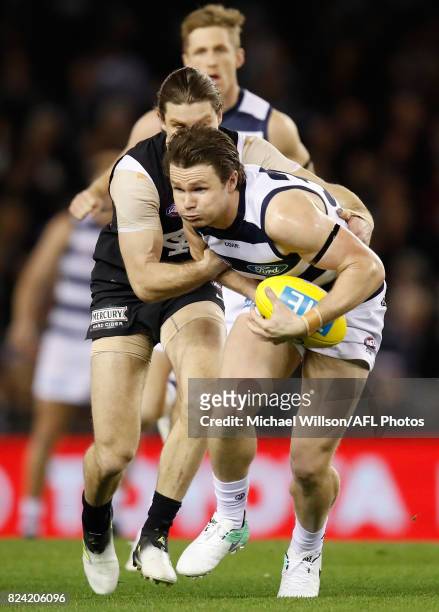 Patrick Dangerfield of the Cats is tackled by Bryce Gibbs of the Blues during the 2017 AFL round 19 match between the Carlton Blues and the Geelong...