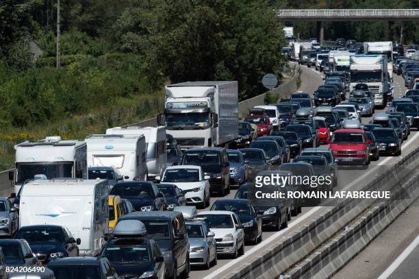 Motorists drive southbound on the A7 highway near Valence, southeastern France, on July 29, 2017 during a busy traffic weekend of the annual summer...