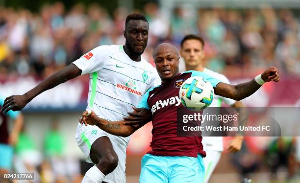 Ludovic Sane of Bremen and Andre Ayew of West Ham battle for the ball during the pre-season friendly match between Werder Bremen and West Ham United...