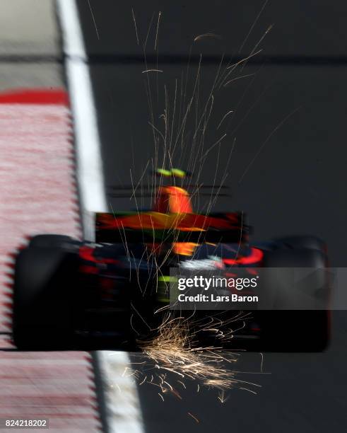 Sparks fly behind Max Verstappen of the Netherlands driving the Red Bull Racing Red Bull-TAG Heuer RB13 TAG Heuer on track during final practice for...