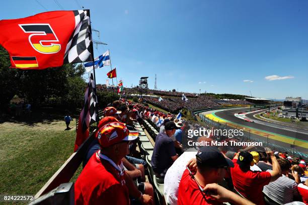 Fans watch as Sebastian Vettel of Germany driving the Scuderia Ferrari SF70H rounds the last corner during qualifying for the Formula One Grand Prix...