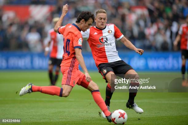 Ruben Pardo from Real Sociedad is tackled by Jens Toornstra from Feyenoord during the friendly match between Feyenoord and Real Sociedad at De Kuip...