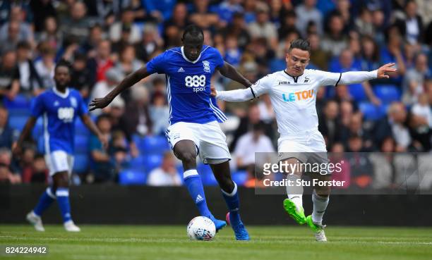 Swansea player Roque Mesa challenges Cheikh Ndoye of Birmingham during the Pre Season Friendly match between Birmingham City and Swansea City at St...