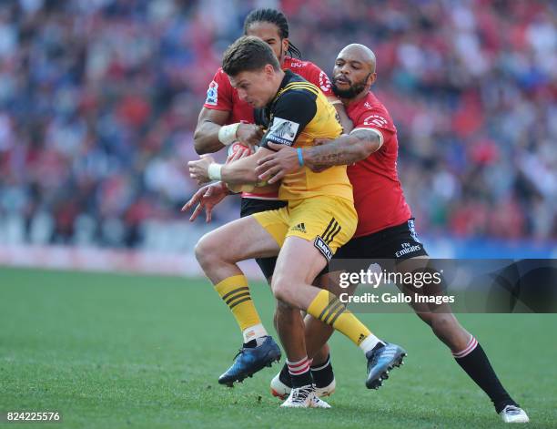 Lionel Mapoe and Courtnall Skosan of Lions in action with Beauden Barrett of Hurricanes during the Super Rugby, Semi Final match between Emirates...